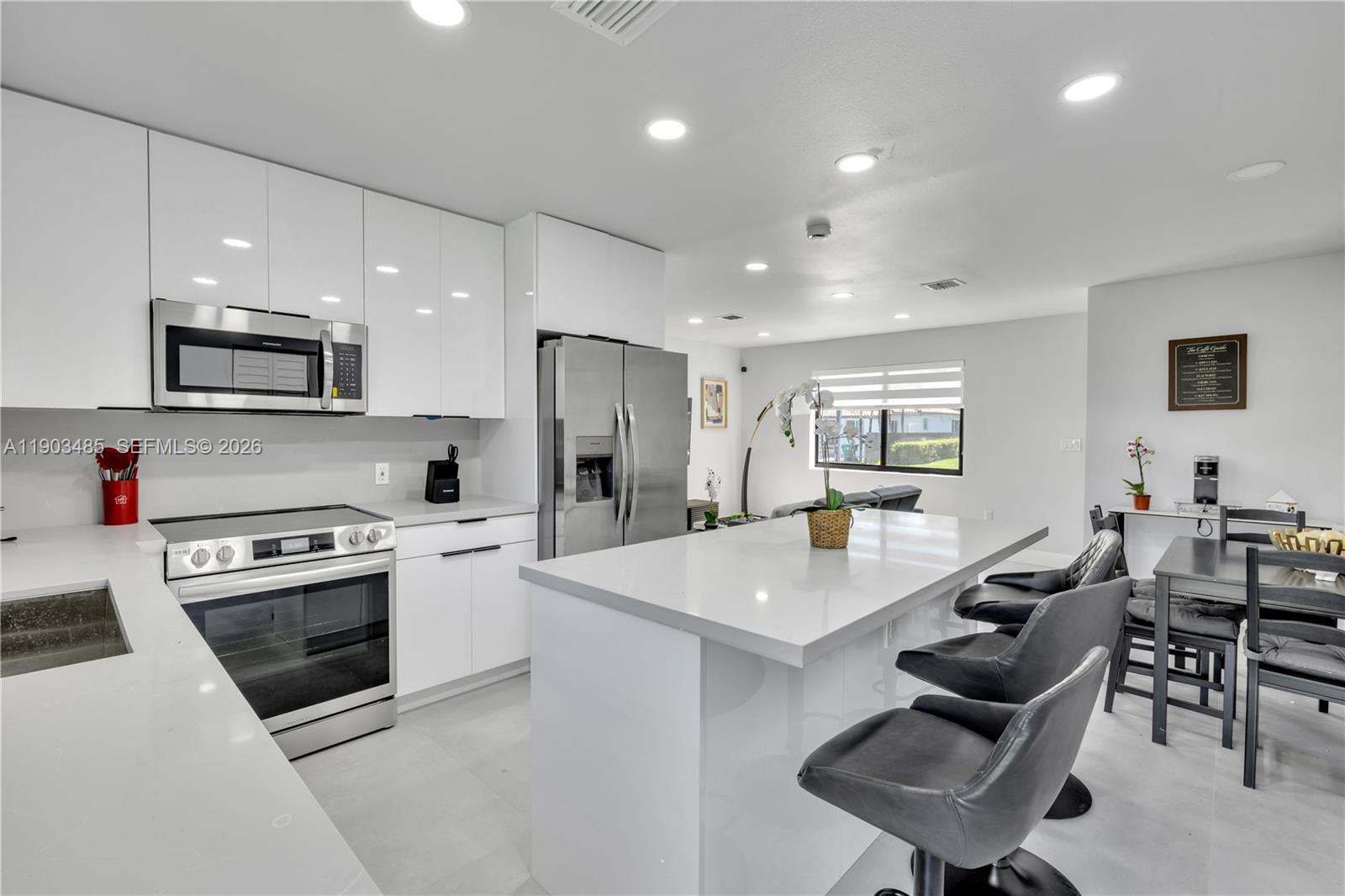 A single-story house features a light-colored exterior, a paved driveway, and a grassy front yard — 6021 SW 19th St, Miami FL 33155, MIAMI, FL