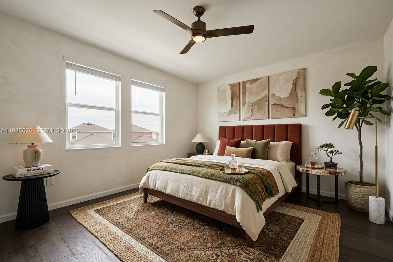 A bedroom features a bed with a rust-colored headboard, a ceiling fan, and two windows — 6349 Blissful Street, Clermont FL 34714, CLERMONT, FL