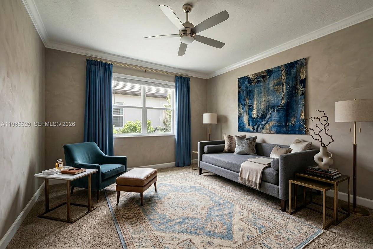 A living room features a gray sofa, blue accent chair, area rug, and ceiling fan — 6349 Blissful Street, Clermont FL 34714, CLERMONT, FL