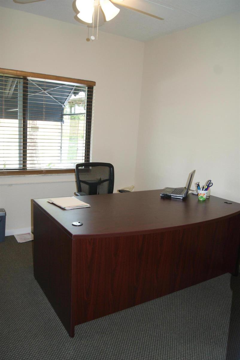 An office features a dark wood desk, a black mesh chair, and a window with blinds — 766 SE 5th Avenue, Delray Beach FL 33483, DELRAY BEACH, FL