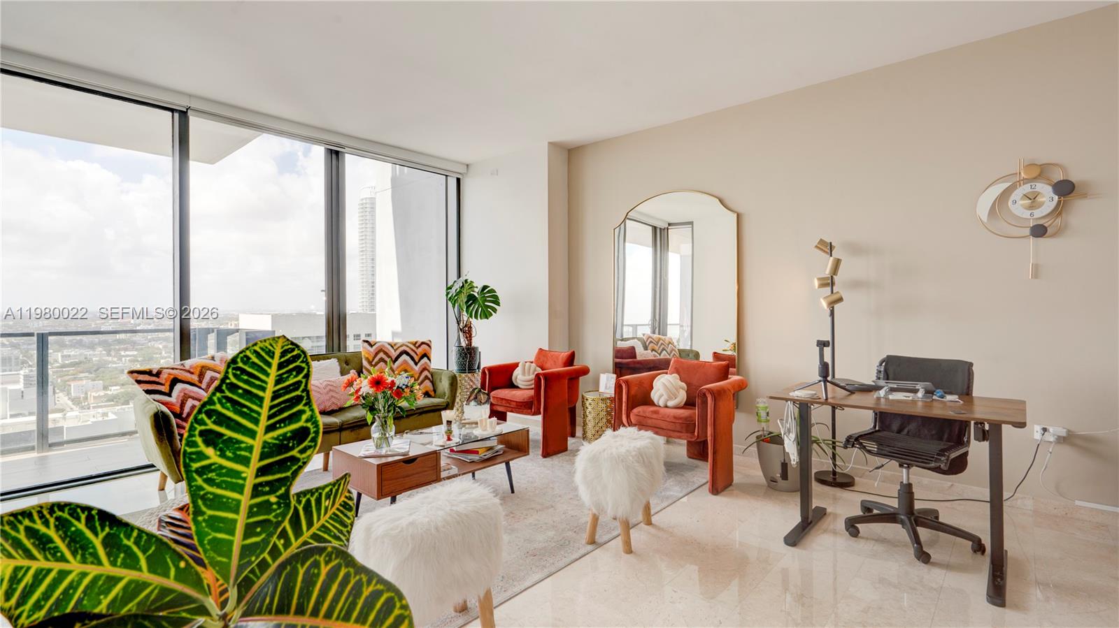 A living room with a desk, velvet chairs, a sofa, and floor-to-ceiling windows — 88 SW 7th St # 2706, Miami FL 33130, MIAMI, FL