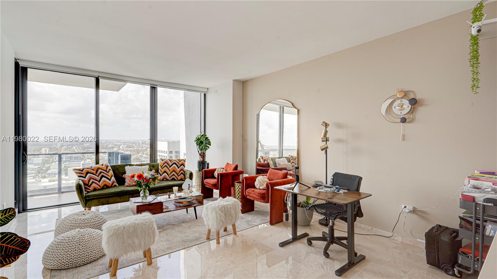 A living room features floor-to-ceiling windows, a green sofa, two red chairs, and a desk — 88 SW 7th St # 2706, Miami FL 33130, MIAMI, FL