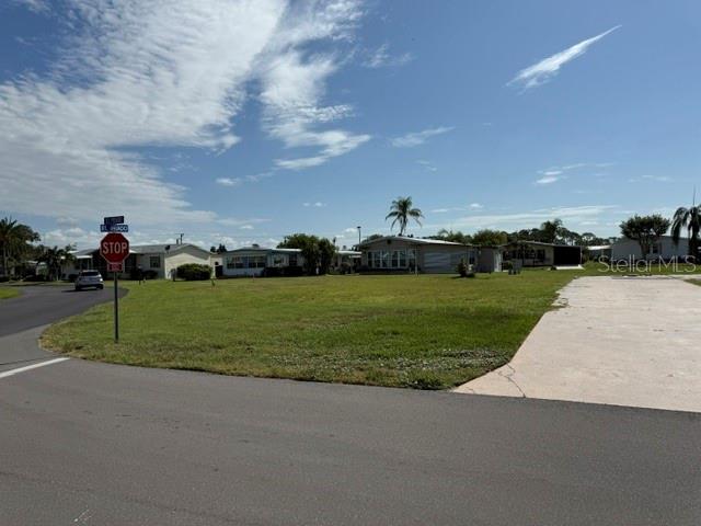 A street view shows a grassy corner lot with a stop sign and nearby houses — 401 EL PRADO, NORTH PORT, FL