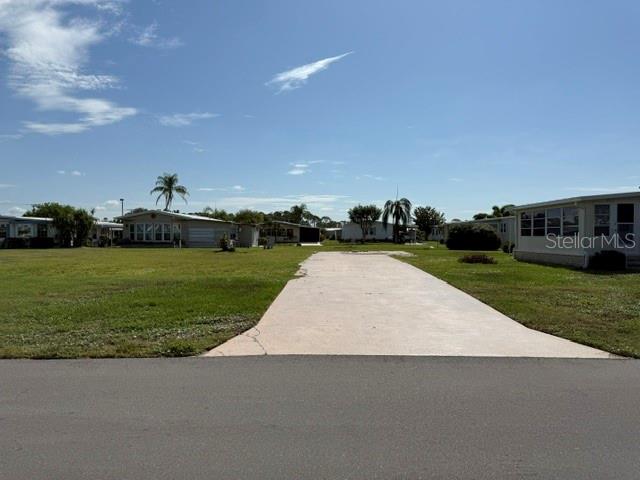 A concrete driveway leads to a vacant lot in a mobile home community — 401 EL PRADO, NORTH PORT, FL