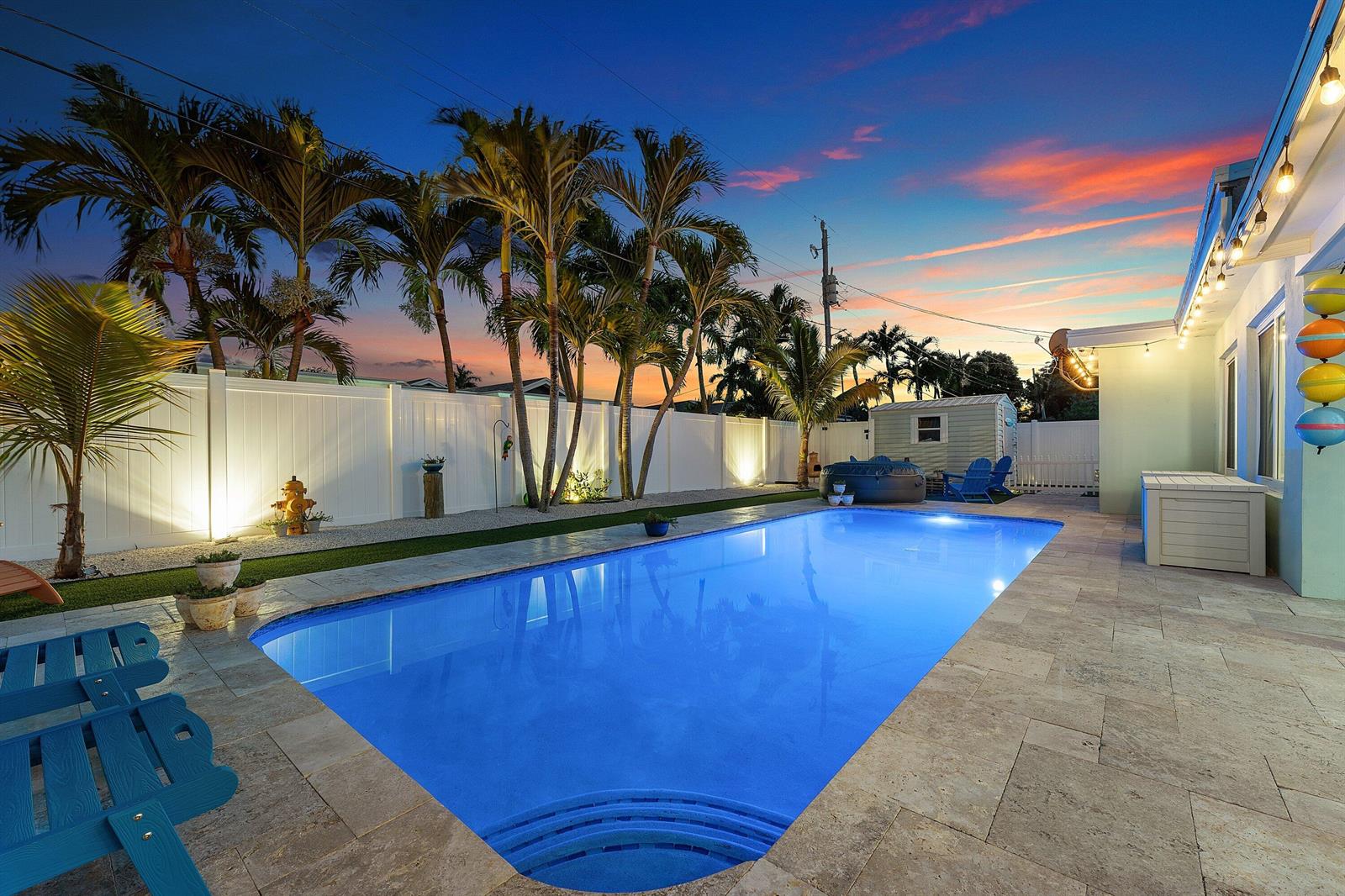 A backyard swimming pool with a stone patio, palm trees, and a white privacy fence — 904 SE 15th Court, Deerfield Beach FL 33441, DEERFIELD BEACH, FL