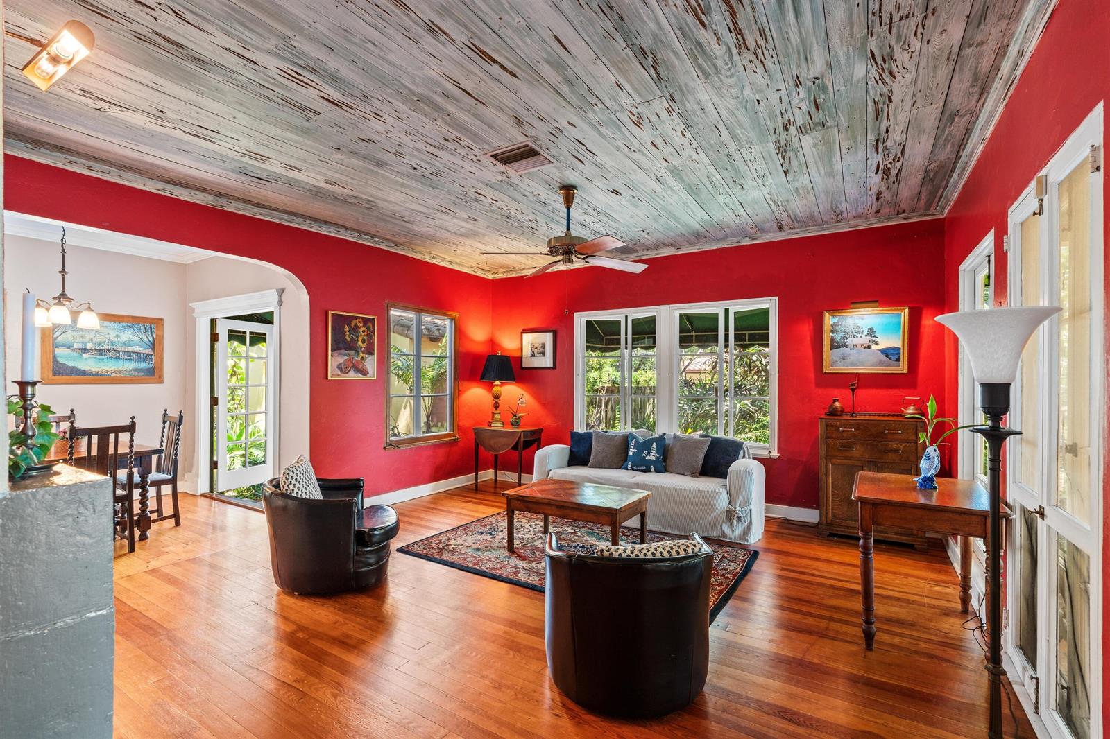 A living room with red walls, a distressed wood ceiling, and hardwood floors — 825 Alamanda Street, Boca Raton FL 33486, BOCA RATON, FL