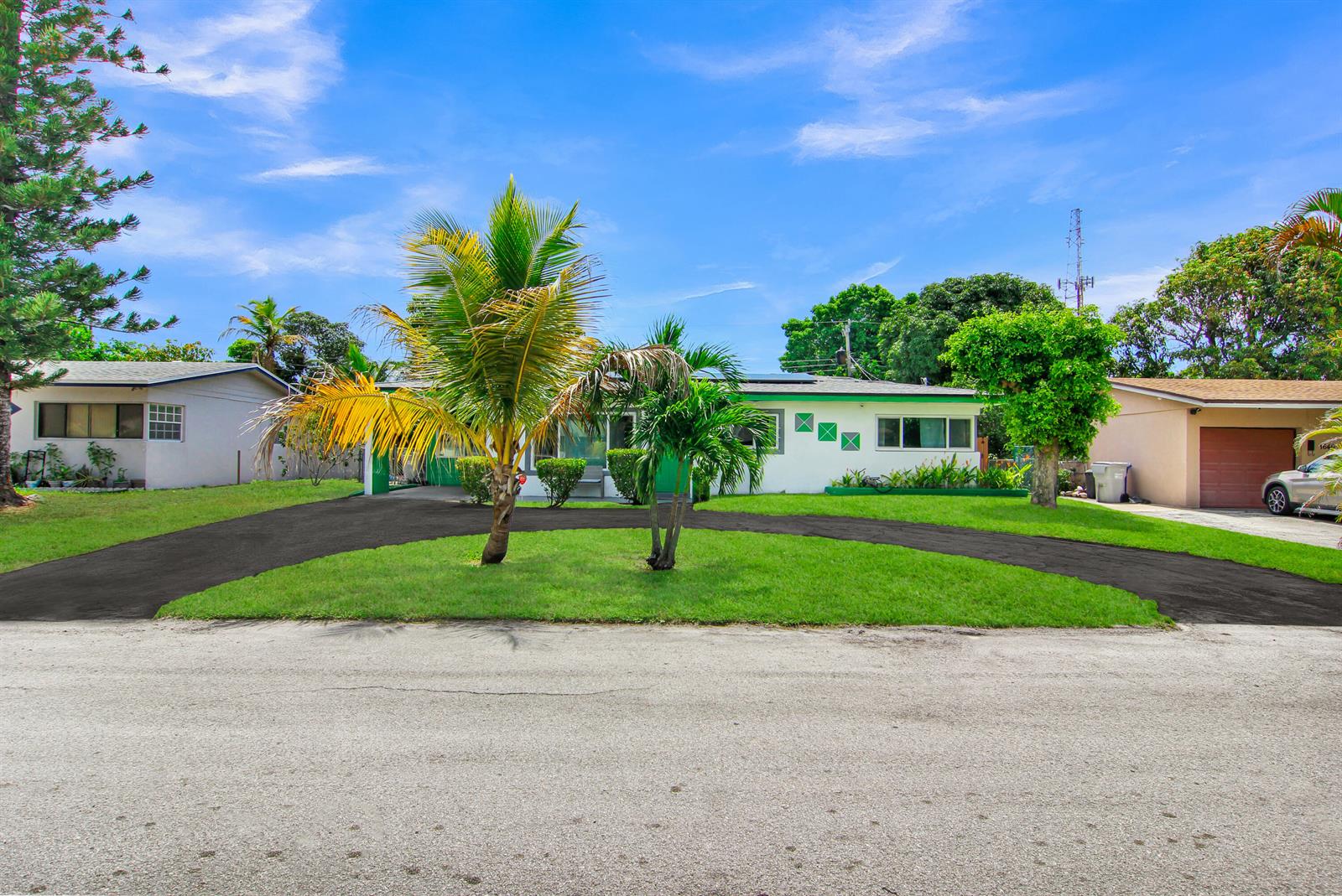 A backyard features a rectangular swimming pool, a tiled patio, and a grassy lawn — 1650 NW 1st Way, Pompano Beach FL 33060, POMPANO BEACH, FL