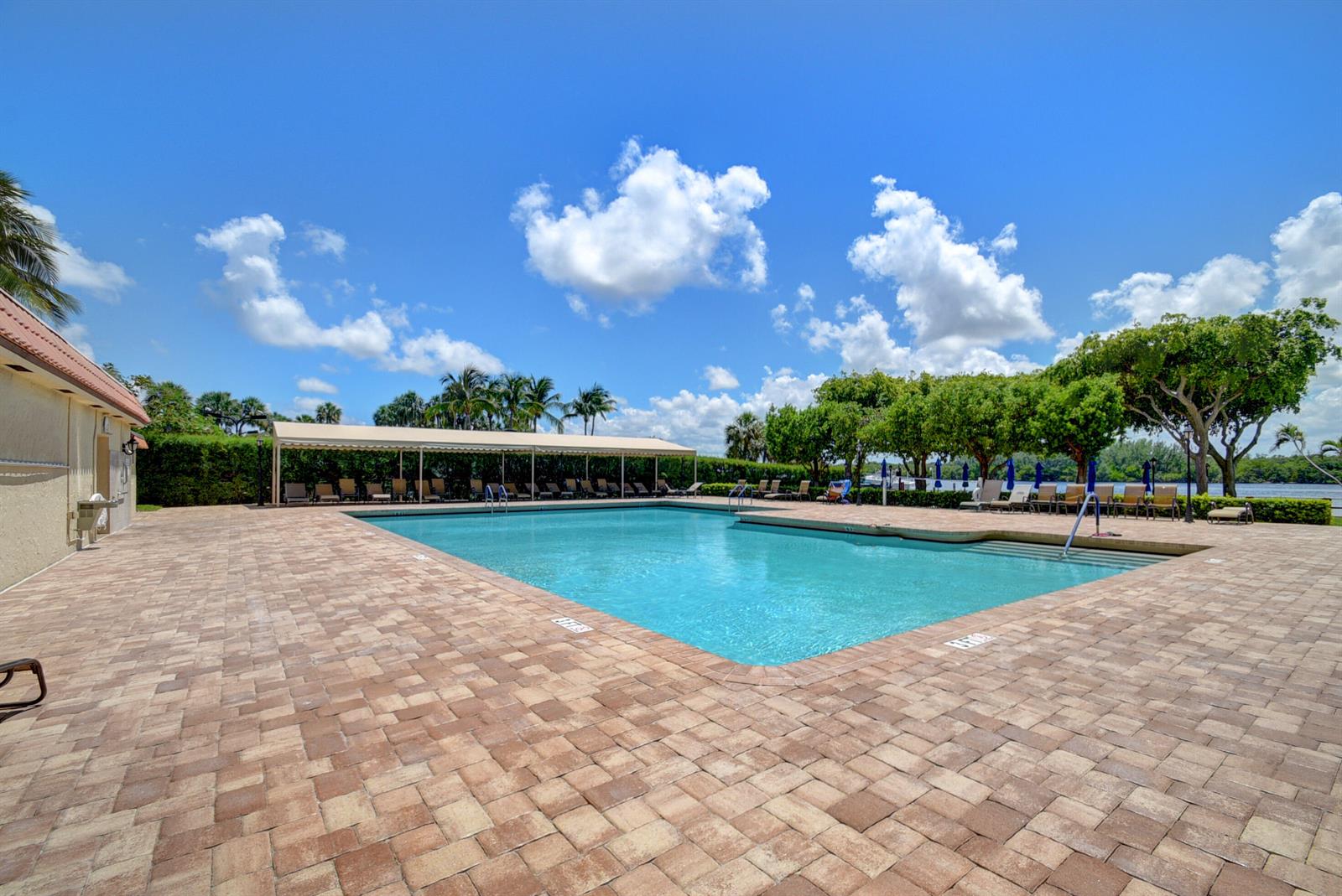 A rectangular outdoor swimming pool with a covered patio area and paved deck — 2121 N Ocean Boulevard # 1406w, Boca Raton FL 33431, BOCA RATON, FL