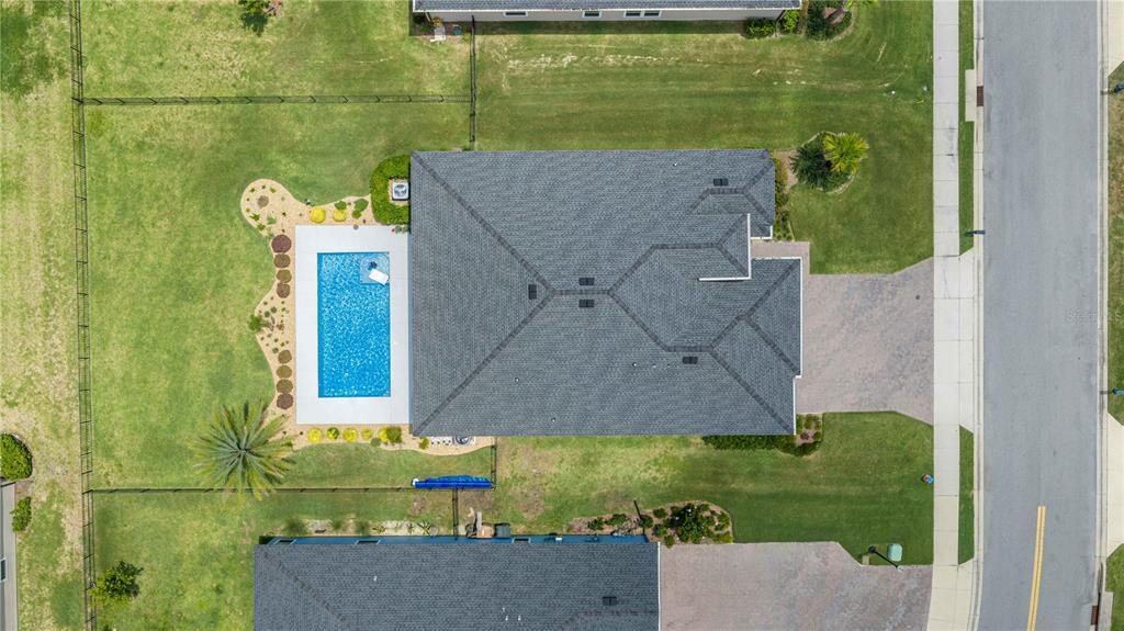 An aerial view shows a house with a shingled roof, a pool, and a fenced yard — 4227 SE 11TH AVENUE, OCALA, FL