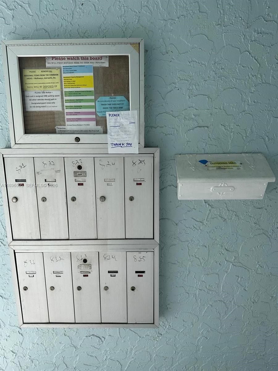 A wall-mounted bulletin board, a set of ten mailboxes, and an outgoing mail bin — 9848 Marina Blvd # 811, Boca Raton FL 33428, BOCA RATON, FL