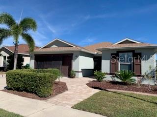 A single-story house with a light-colored stucco exterior, a paved walkway, and a palm tree — 9975 BISHOP CREEK WAY, PUNTA GORDA, FL
