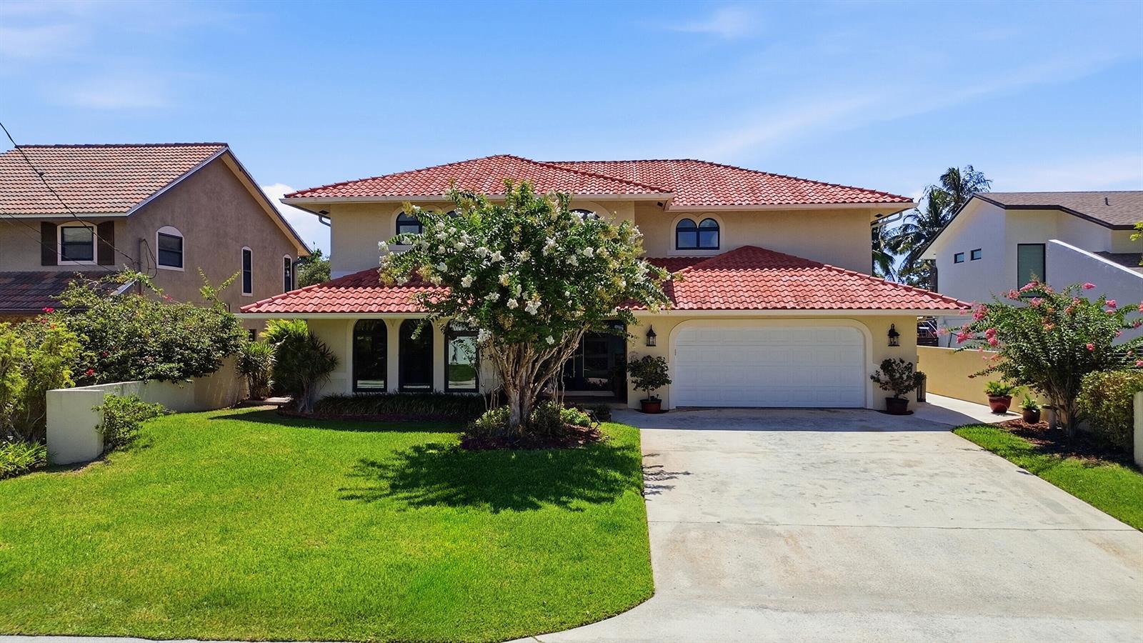 A two-story house with a red tile roof, white garage door, and a front lawn — 370 SE 13th Avenue, Pompano Beach FL 33060, POMPANO BEACH, FL