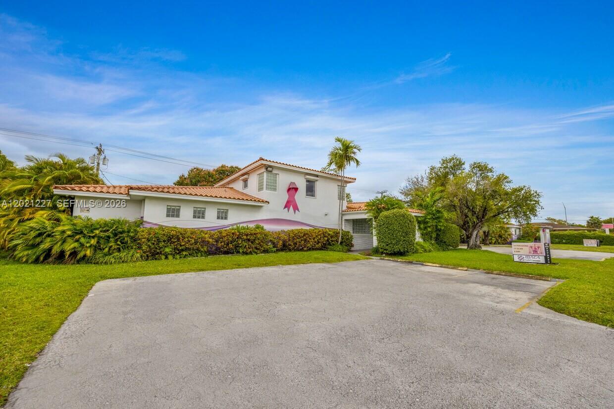 A two-story building with a pink ribbon mural on the exterior wall — 49 W 49TH St, Miami Beach FL 33012, MIAMI BEACH, FL