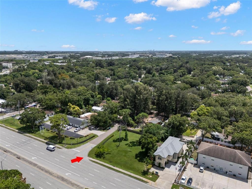 An aerial view shows a grassy corner lot adjacent to a multi-lane road — 5670 ROOSEVELT BOULEVARD UNIT #4, CLEARWATER, FL