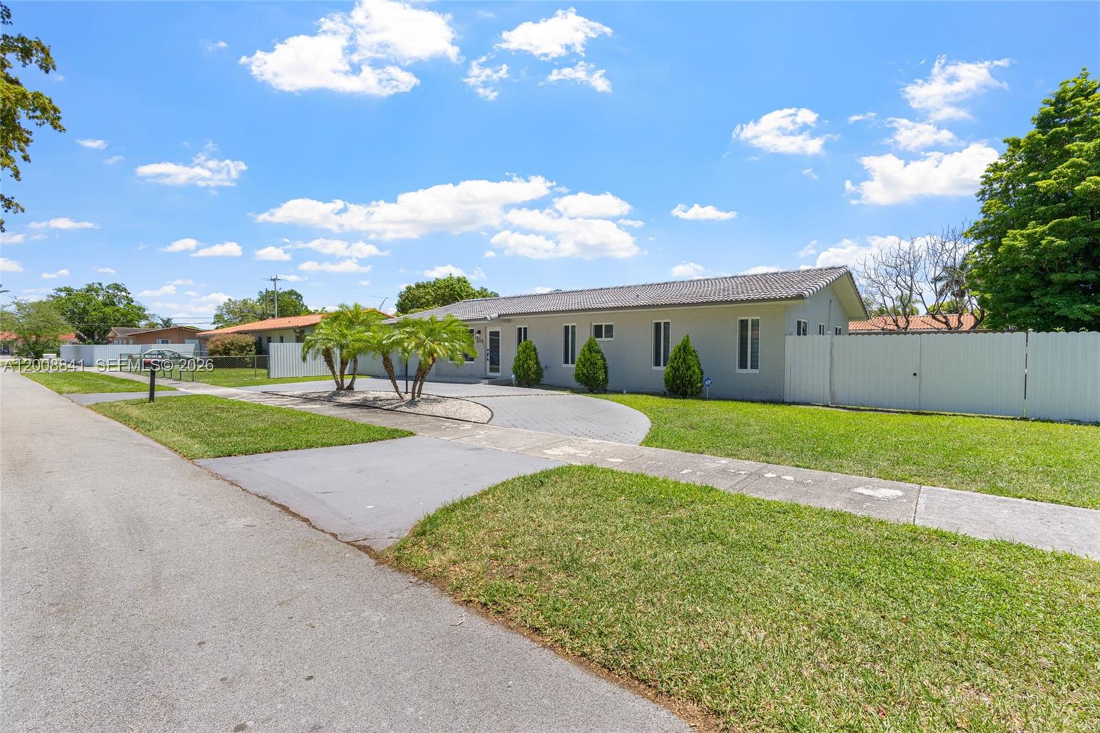 A single-story house with a gray exterior, a tiled roof, and a paved driveway — 12724 SW 33rd Ter, Miami FL 33175, MIAMI, FL