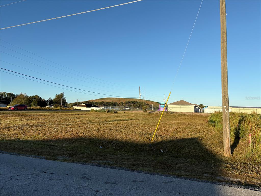 A vacant, grassy lot sits next to a utility pole under a clear blue sky — 0 DOGWOOD ROAD, OCALA, FL