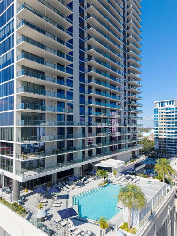 An aerial view of a high-rise apartment building with balconies overlooking a swimming pool deck — 275 1ST AVENUE S UNIT 2807, ST PETERSBURG, FL
