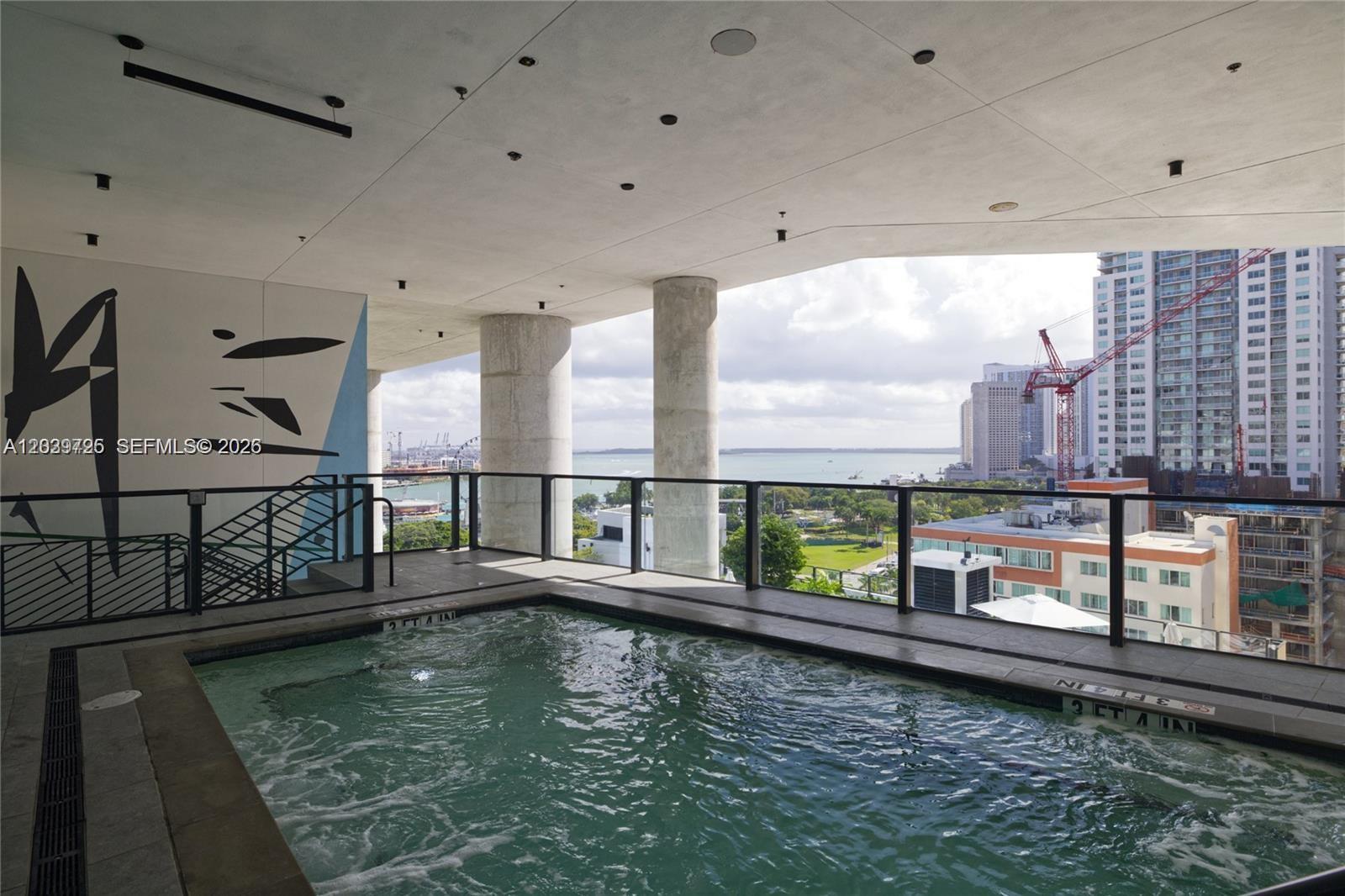 An elevated outdoor hot tub overlooks a city skyline and a body of water — 398 NE 5th St # 2112, Miami FL 33132, MIAMI, FL