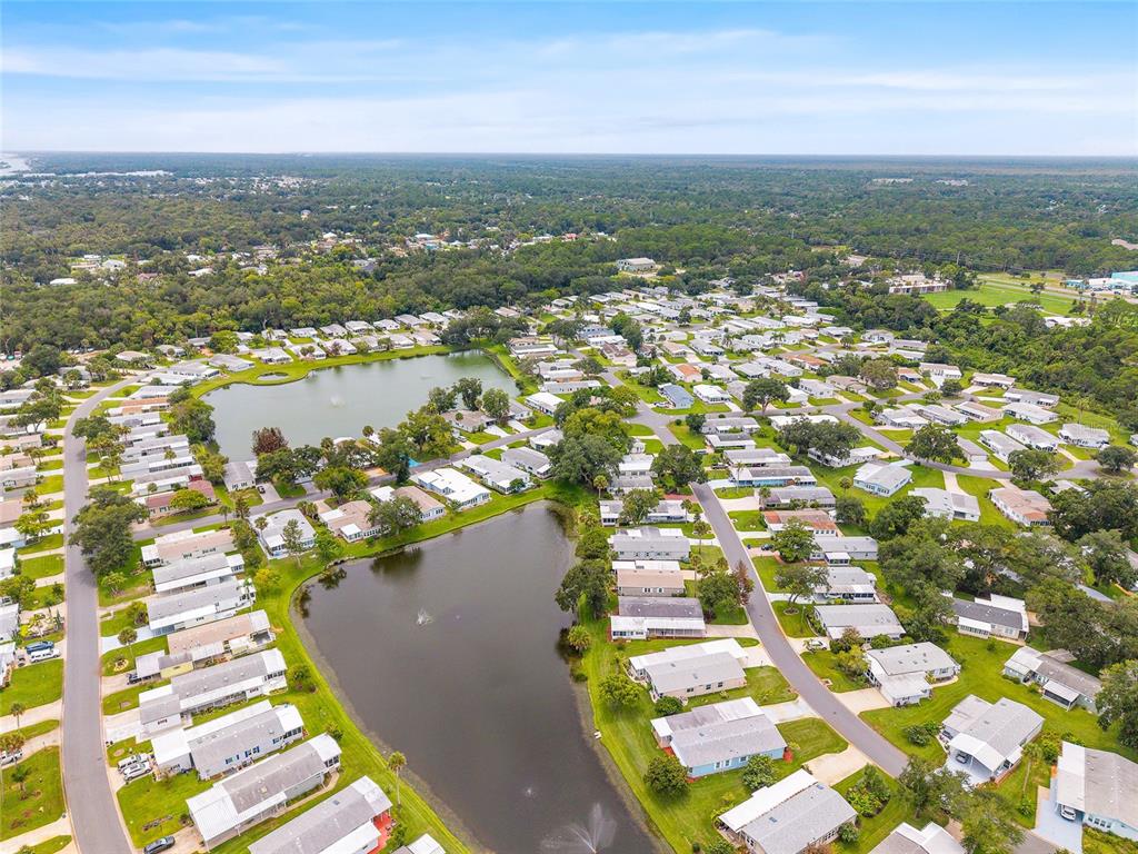 An aerial view shows a residential community with many houses surrounding two small lakes — 621 STARBOARD AVENUE, EDGEWATER, FL
