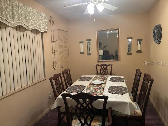 A dining room features a table with six chairs, a mirror, and a ceiling fan — 532 BAHIA CIRCLE UNIT A, OCALA, FL