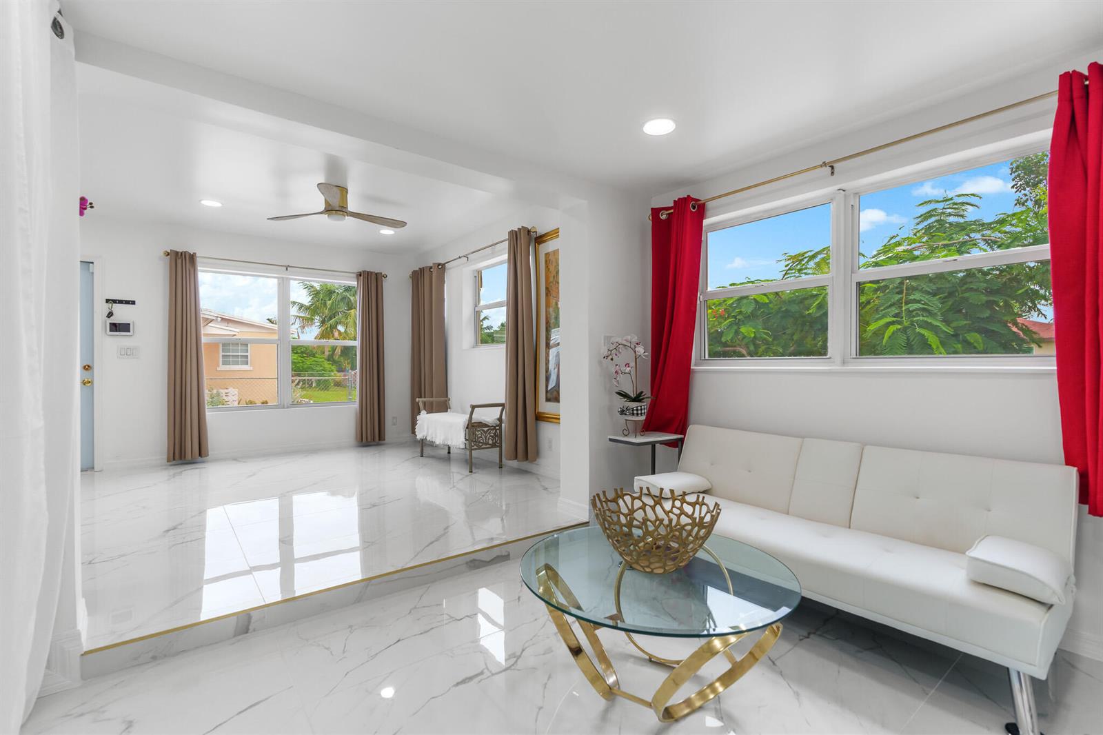 A living room with white marble floors, a sunken area, and a white sofa — 201 NE 28th Court, Boynton Beach FL 33435, BOYNTON BEACH, FL