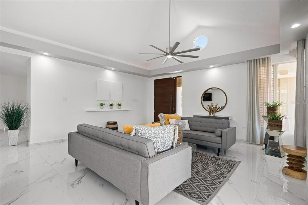 A living room features white marble floors, a vaulted ceiling with a fan, and sofas — 170 CAMINO DE LOS JAZMINES, DORADO, PR