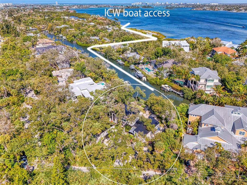 An aerial view shows a house circled in white with access to a nearby waterway — 5303 HIDDEN HARBOR ROAD, SARASOTA, FL