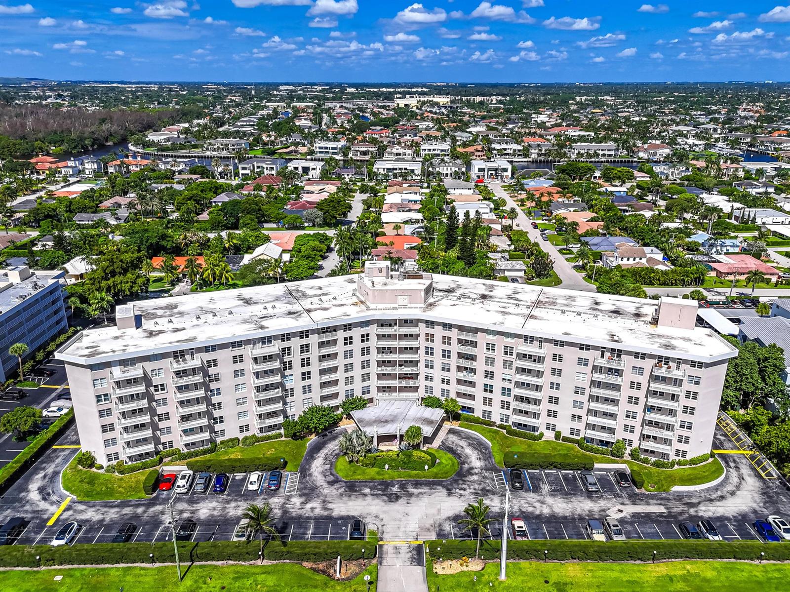 An aerial view of a multi-story apartment building with a large parking lot in front — 2851 S OCEAN Boulevard # 0086, Boca Raton FL 33432, BOCA RATON, FL