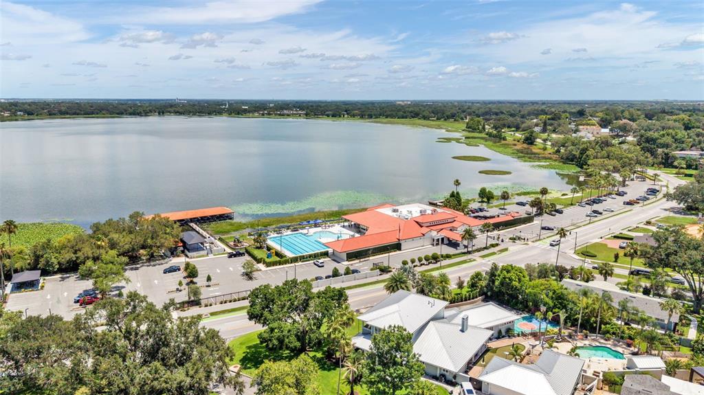 An aerial view shows a community center with a pool beside a large lake — 2303 COVENTRY AVENUE, LAKELAND, FL