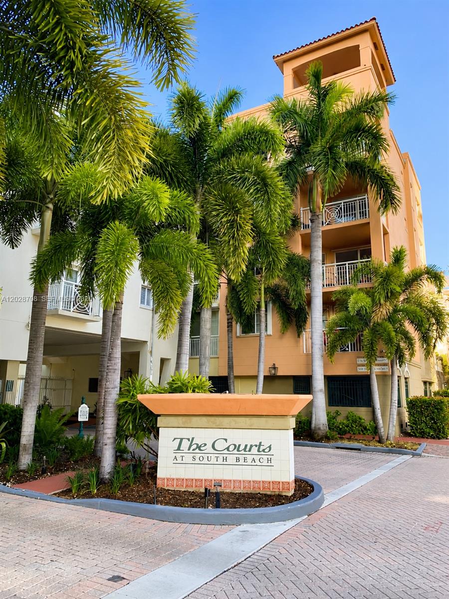 The exterior of The Courts at South Beach apartment complex features palm trees and balconies — 145 Jefferson Ave # 415, Miami Beach FL 33139, MIAMI BEACH, FL
