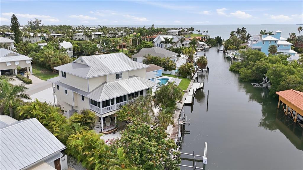 An aerial view of a waterfront house with a metal roof and a private dock — 505 59TH STREET, BRADENTON BEACH, FL