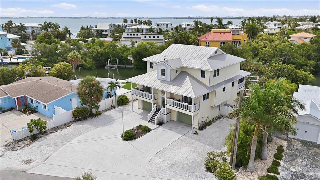 A bright living room features a large sectional sofa, a blue area rug, and tile floors — 505 59TH STREET, BRADENTON BEACH, FL