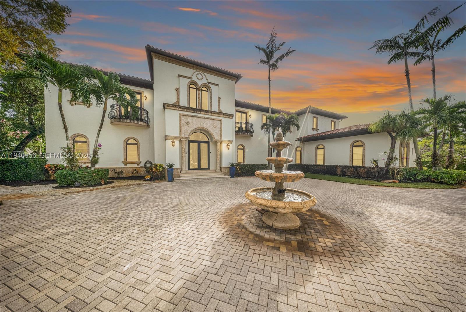 A large Mediterranean-style house features a stone fountain in a paved circular driveway — 7538 SW 64th St, Miami FL 33143, MIAMI, FL