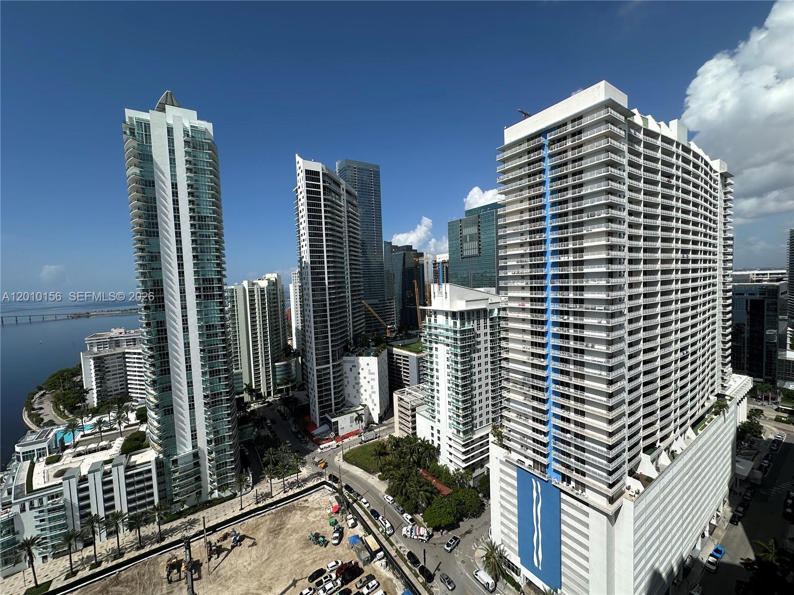 An elevated view of several modern high-rise residential buildings in a dense urban setting — 1155 Brickell Bay Dr # 3007, Miami FL 33131, MIAMI, FL