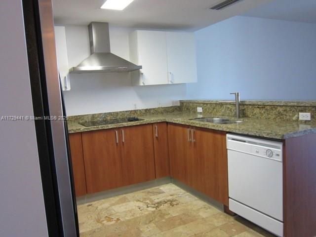 A kitchen features wood-toned lower cabinets, white upper cabinets, granite countertops, and stainless steel appliances — 170 SE 14th St # 2306, Miami FL 33131, MIAMI, FL
