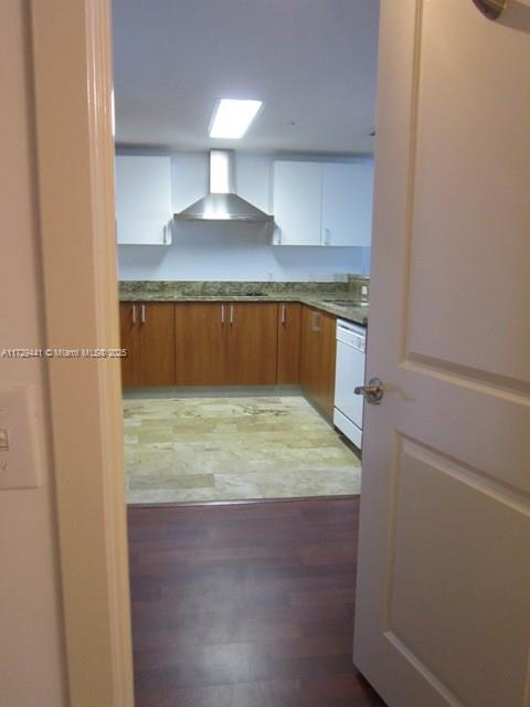 A kitchen with wood cabinets, stone countertops, and a stainless steel range hood — 170 SE 14th St # 2306, Miami FL 33131, MIAMI, FL