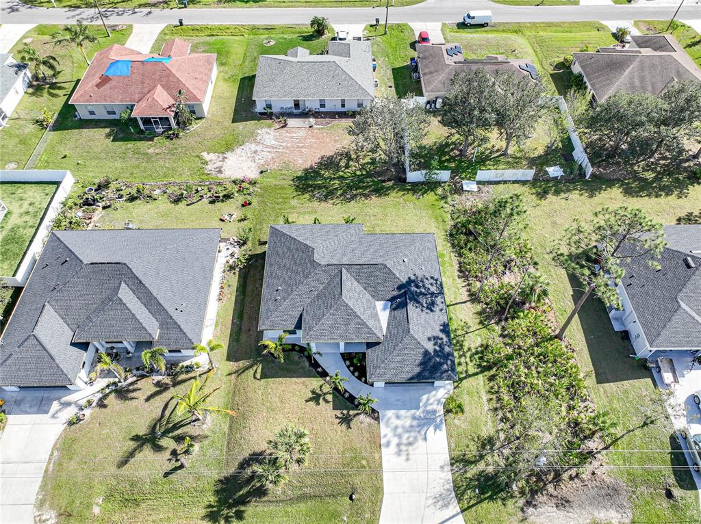 An aerial view shows several suburban houses with driveways, lawns, and trees — 3600 CINCINNATI STREET, NORTH PORT, FL