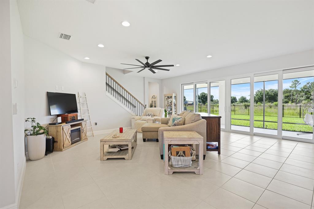 A bright entryway features light tile flooring, a glass-paneled double front door, and French doors — 13180 WELLSPRING DRIVE, LITHIA, FL