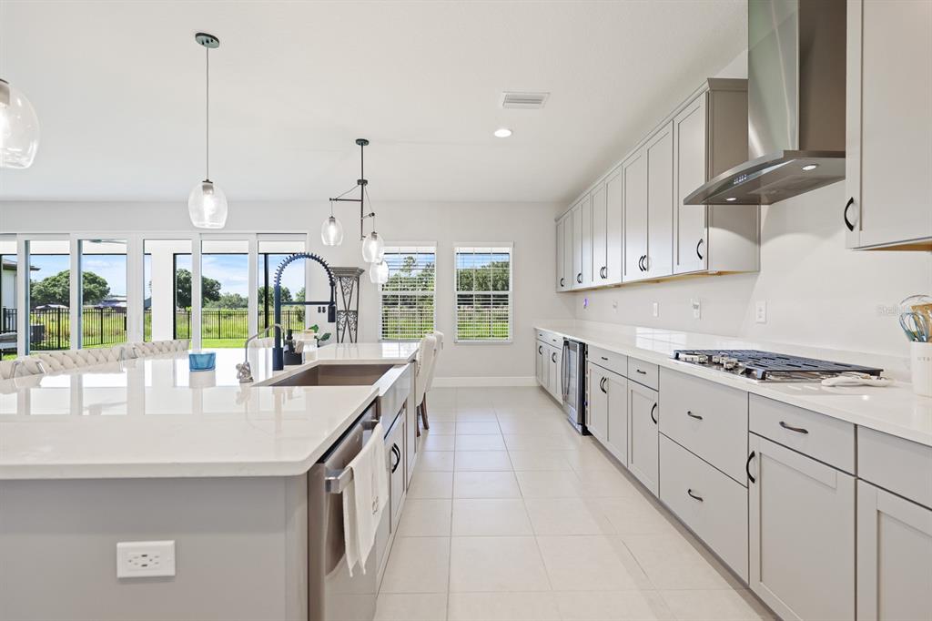 An empty room with light gray walls, tile flooring, a ceiling fan, and two windows — 13180 WELLSPRING DRIVE, LITHIA, FL