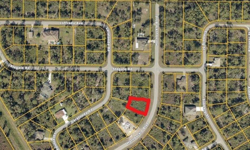 This is an aerial map showing a vacant lot outlined in red within a residential neighborhood — HORNBUCKLE BOULEVARD, NORTH PORT, FL