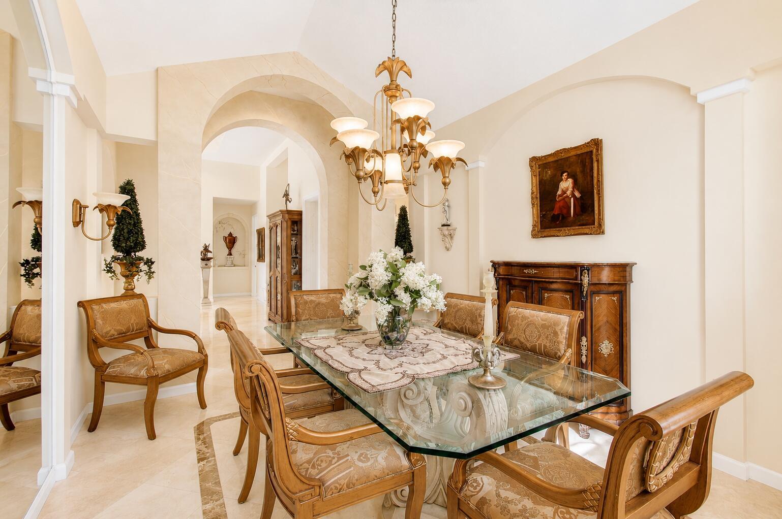 A formal dining room features a glass-topped table, ornate wooden chairs, and a gold chandelier — 6850 Fiji Circle, Boynton Beach FL 33437, BOYNTON BEACH, FL