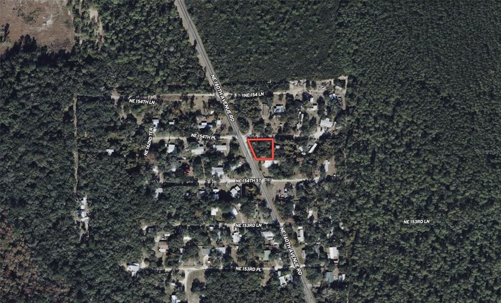 An aerial map shows a vacant lot outlined in red along a rural road — NE 154TH PLACE, FORT MC COY, FL