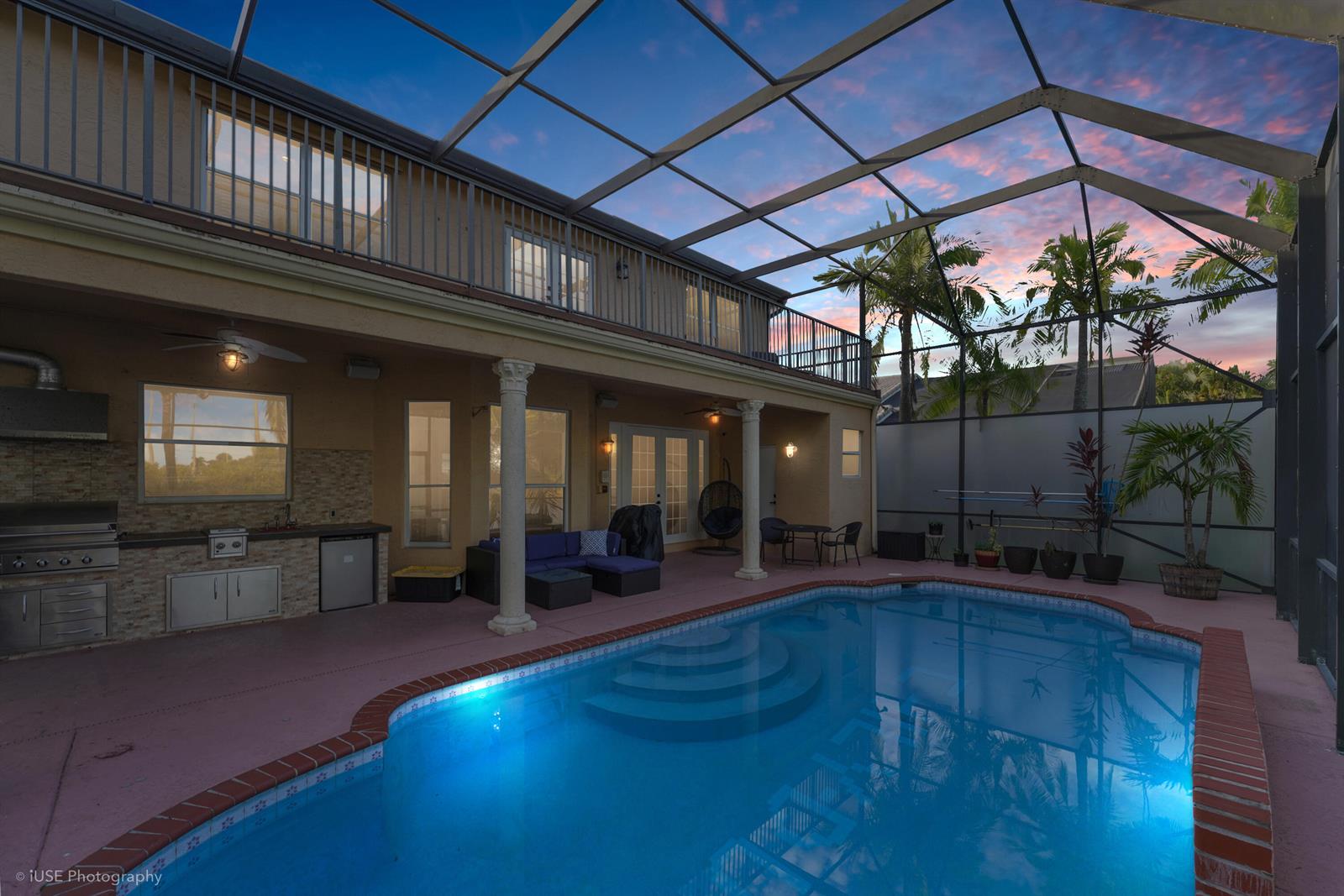 A covered patio with an outdoor kitchen and pool enclosed by a screen cage — 3181 SW 173rd Terrace, Miramar FL 33029, MIRAMAR, FL