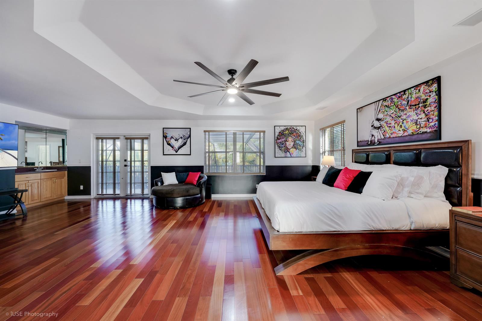 A spacious bedroom features hardwood floors, a tray ceiling, and a large bed — 3181 SW 173rd Terrace, Miramar FL 33029, MIRAMAR, FL