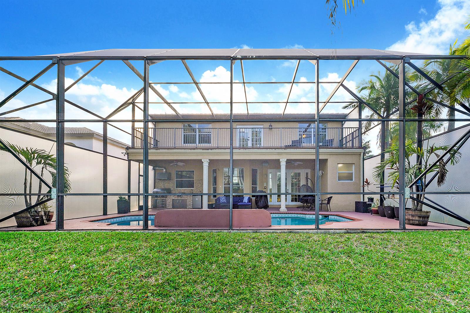 A two-story house with a screened-in pool and patio area viewed from the backyard — 3181 SW 173rd Terrace, Miramar FL 33029, MIRAMAR, FL