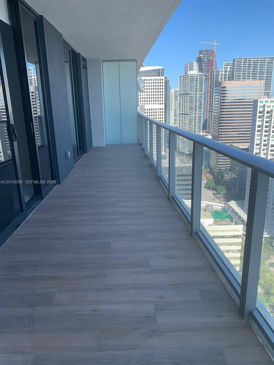 A view of a city skyline and bay from a high-rise balcony — 1010 Brickell Ave # 3704, Miami FL 33131, MIAMI, FL