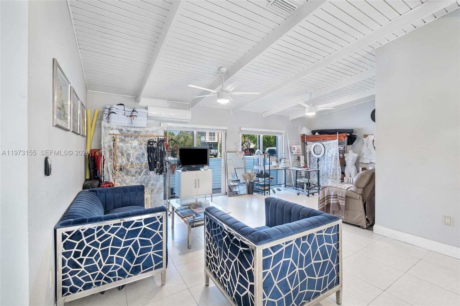 A living area features blue velvet chairs, white tile floors, and a vaulted ceiling — 13710 SW 18th Ter, Miami FL 33175, MIAMI, FL