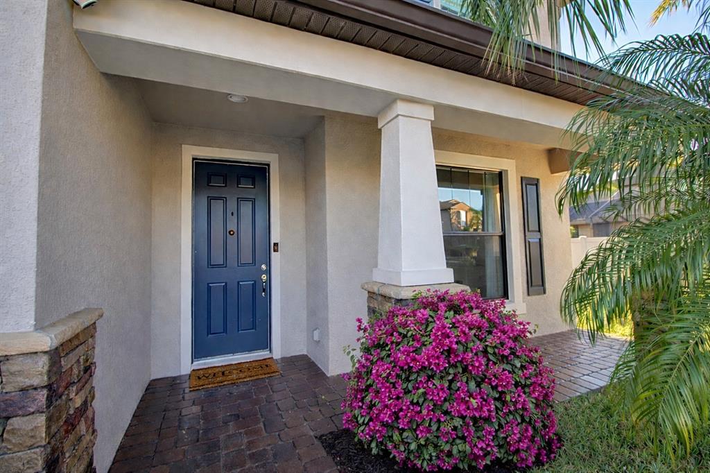 A kitchen features wood cabinets, granite countertops, a center island with bar seating, and stainless appliances — 1907 BOTTLEBRUSH WAY, NORTH PORT, FL