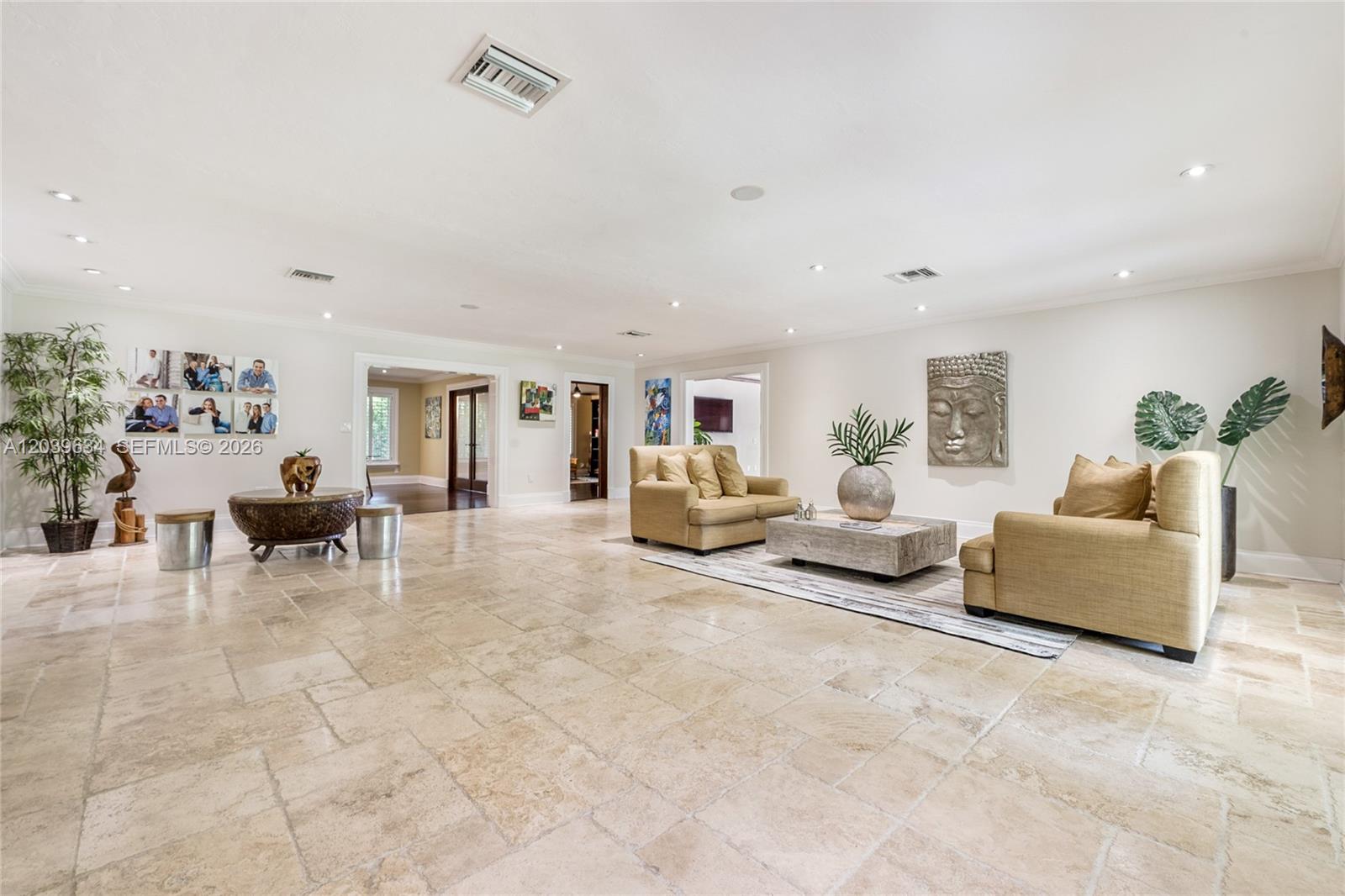A spacious living room features beige tile flooring, two tan sofas, and neutral wall decor — 11900 SW 63rd Ave, Pinecrest FL 33156, PINECREST, FL