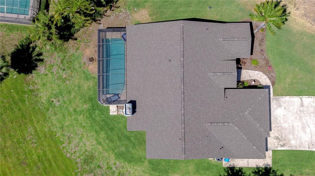 An aerial view shows a house with a shingled roof, a screened pool, and driveway — 709 SPORTSMAN PARK DRIVE, SEFFNER, FL